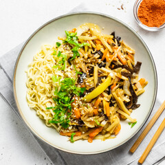 Mushroon vegetable stri fry and noodles in a bowl. Top view, copy space.