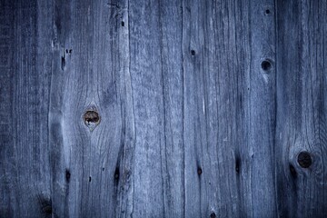 Fototapeta premium Dark wood boards texture close up. Vintage wooden surface background. Unpainted natural hardwood boards texture. Weathered surface of the old planks of wooden wall close-up. High contrast wood.