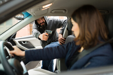 Angry thief stealing a car from a victim
