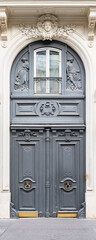 Paris, an ancient wooden door, beautiful facade in the 11e arrondissement
