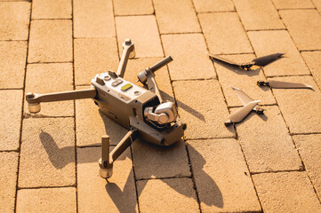 Crashed drone lays on the ground and damaged