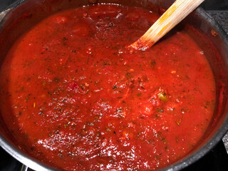 Thick spaghetti sauce simmering on the stove