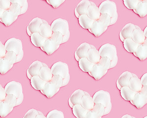 Pattern from hearts made of rose petals on pink background. Heart form from white petals. Minimal Valentines layout for February 14. Festive valentine day concept. Flat lay, pastel color
