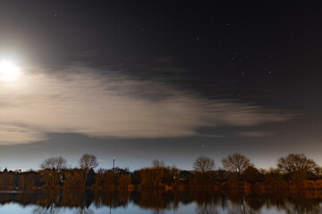 Full moon evening by a lake in a town in England