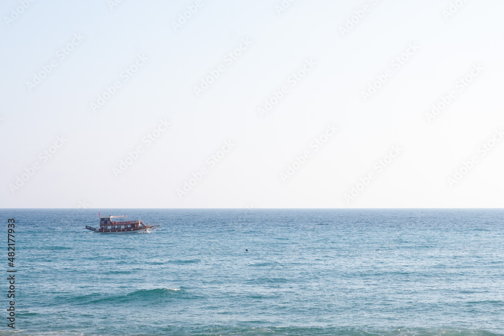 Wall mural boat on the sea