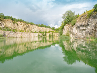 Fototapeta na wymiar Blue green water of flooded Janicuv mine. The swamped Janicuv vrch