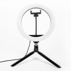 LED ring lamp on a small tripod. White background.