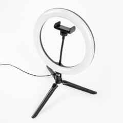 LED ring lamp on a small tripod. White background.