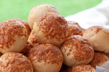 several small loaves of bread in a basket, on a buffet table 