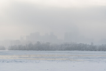 View of the city in winter. Air pollution from smog