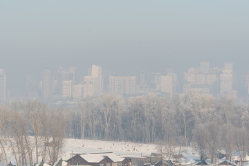 View of the city in winter. Air pollution from smog