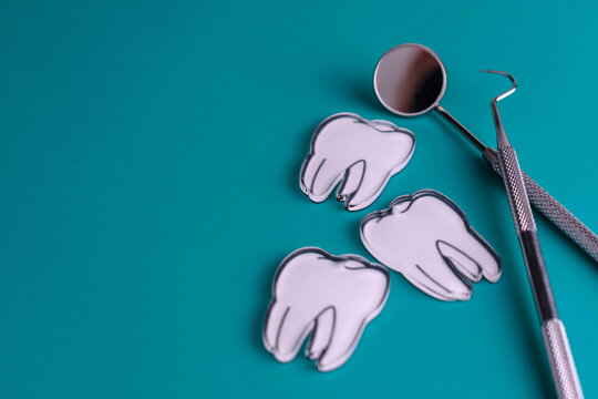 Dental instruments and teeth. Dentist visit concept. Copy space.	