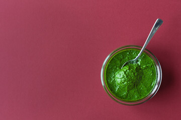 Bowl with green chutney sauce dip from leaves. Top view with copy space.