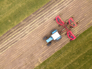 Aerial top down drone photo. Agriculture tractor with seeding irrigation system on parking. Russia.