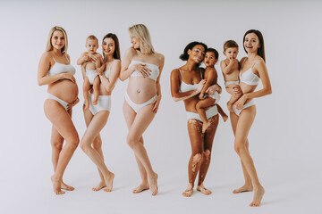 Beauty shot of beautiful pregnant women and mothers holding babies, motherhood and pregnancy concept