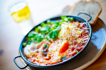 Egg shakshouka dish on a restaurant table