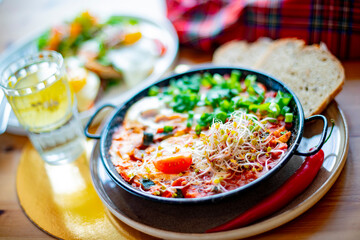 Egg shakshouka dish on a restaurant table