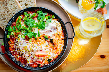 Egg shakshouka dish on a restaurant table