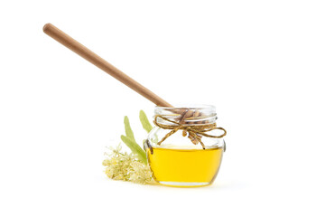 Honey jar with linden blossom and wooden dipper isolated on white