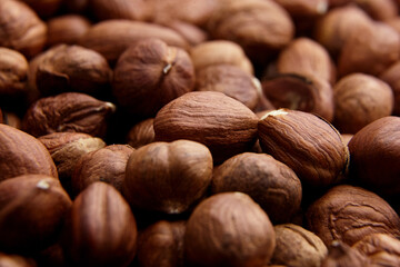 Shelled raw hazelnuts background closeup