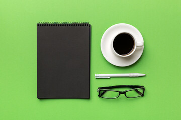 Obraz na płótnie Canvas Modern office desk table with notebook and other supplies with cup of coffee. Blank notebook page for you design. Top view, flat lay