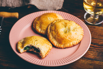 Oven Baked Pastries with Blue Chives and Mushrooms. One with Bite Taken Out of It