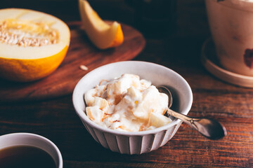 Bowl of Ice Cream Mixed with Melon and Covered with Berry Syrup