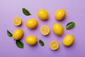 Many fresh ripe lemons as colored background, top view. Elegant background of lemon and lemon slices Top view flat lay