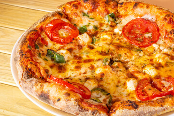 close up pizza with tomatoes and cheese