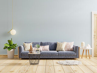 Modern interior design with sofa on empty blue wall background.