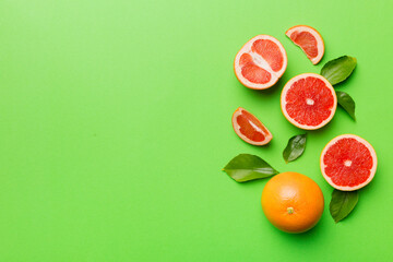 fresh Fruit grapefruit with Juicy grapefruit slices on colored background. Top view. Copy Space. creative summer concept. Half of citrus in minimal flat lay with copy space