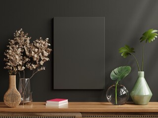 Mockup black frame on cabinet in living room interior on empty dark wall background.