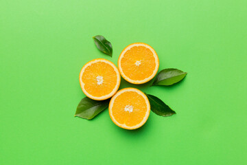 Fruit pattern of fresh orange slices on colored background. Top view. Copy Space. creative summer concept. Half of citrus in minimal flat lay