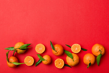 Many fresh ripe mandarin with green leaves on colored background, top view, space for text