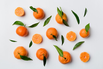 Many fresh ripe mandarin as colored background, top view. Elegant background of clementines and mandarin slices Top view flat lay