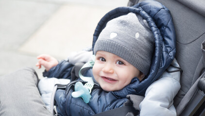 Happy newborn baby outside during winter