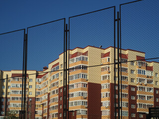 urban landscape walls of a new apartment building behind bars