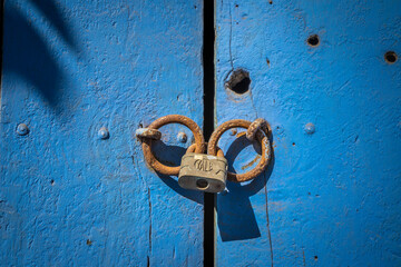 Vintage door lock on blue closed door