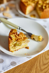 Piece of apple or pear pie, tart with caramel nuts on wooden table, copy space, top view.