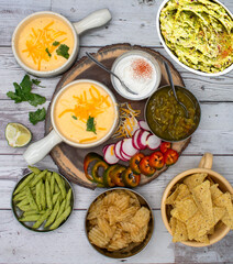 Nacho cheese with a variety of chips and dipping sauces