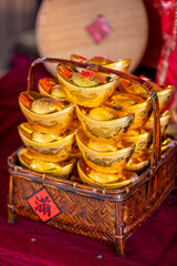 Chinese New Year, traditional ornaments, bamboo baskets, gold ingots