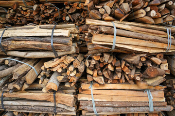Pile of firewood taken from felled trees in the forest. This firewood is commonly used for cooking and making fires to warm the room and body during winter.