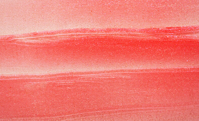 Texture of pink peach color textured lip gloss smear as background close view - obrazy, fototapety, plakaty