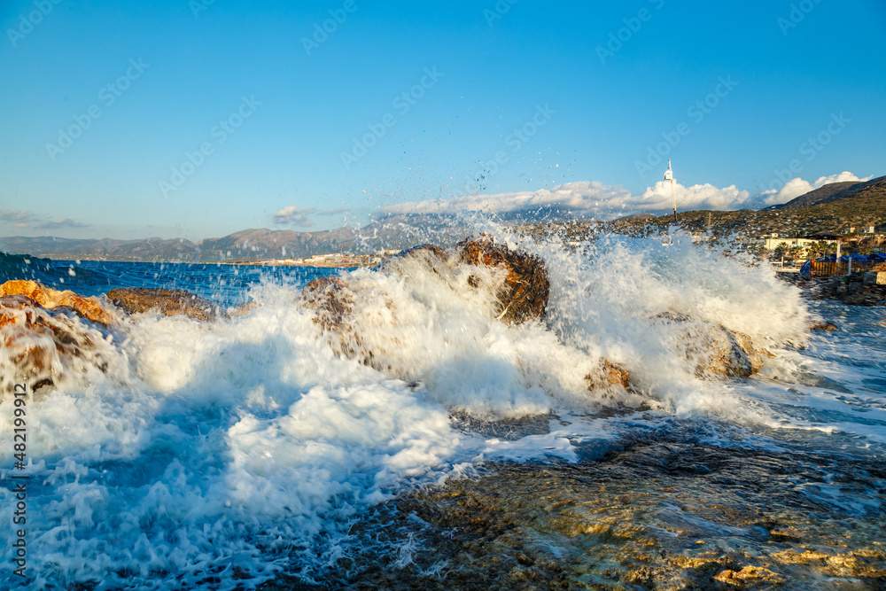 Wall mural beautiful sea landscape with waves breaking on a sandy and rocky beach. waves on background. summer 