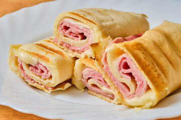 Pancakes with ham and cheese on plate