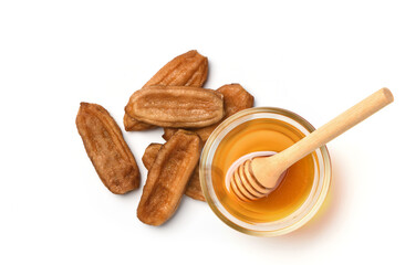 Top view of Natural dried banana (Kluai namwa) with honey isolated on white background.