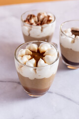 Assortment of mini chocolate and nuts desserts in the glass. Mini choloate desserts on a white background