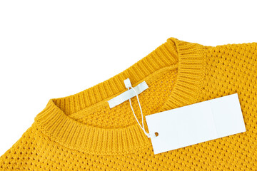 White blank rectangular clothing tag, label mockup template on yellow knitted sweater isolated on...