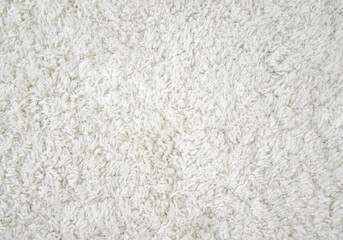 The texture of the carpet. Beige and white carpet, top view, long pile. Background