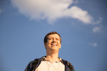 horizontal portrait of a happy man at sunset against the sky